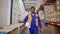 Shot of a confident african warehouse male worker walking in the large distribution storage room holding hardhat in hand