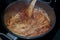 Shot of cooking some homemade delicious spaghetti with tomatoes sauce on top of an oven