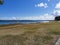 Shot of deserted lakeshore with blue waterscape in the background