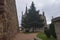 Shot Of The Episcopal Palace Of Gaudi Hidden Behind A Big Pine In Astorga. Architecture, History, Camino De Santiago, Travel,