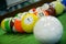 Shot of foot pool balls standing on green table.