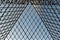 Shot of the glass walls of the Pyramide of Louvre in Paris, France