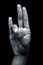 Shot of a hand doing Agni yoga or Surya Mudra or Gesture Of The Fire mudra isolated on black background.