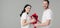 Shot of handsome young man gifting bouquet of red roses to attractive girlfriend isolated on grey