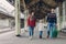 Shot of happy family going to have nice trip during holidays, carry bag, walk on railways station platform, being in good mood.