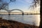 A shot of the Hernando de Soto Bridge over the flowing waters of the Mississippi river with a blue sky at sunset