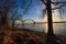 A shot of the Hernando de Soto Bridge over the flowing waters of the Mississippi river with a blue sky at sunset