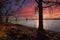 A shot of the Hernando de Soto Bridge over the flowing waters of the Mississippi river with a blue sky at sunset