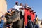 Shot of line of elephants covered in red cloth with tourists riding on them to the landmark hill fort of Amber in Jaipur