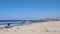 Shot of the lonely sandy beach with sunbed on the stormy windy day. Strong waves hitting and splashing against the seashore