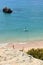 Shot of a lonely surfer in Praia da Prainha - Prainha Beach, Alvor, Portimao, The Algarve, Portugal