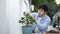 Shot of a man gardener is trimming bonsai tree.