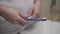 Shot of a man`s hands, who is applying toothpaste on a brush and brush teeth