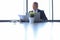 Shot of mature business man in full suit filling documents while sitting in the office