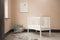 Shot of minimalistic sunny baby\\\'s room interior with child\\\'s bed