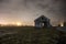 Shot of an old road and shed on a cloudy foggy night