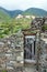 A shot of an old wooden door in an ancient stone slab wall in the city of Corniglia in Cinqueterre, Italy