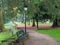 Shot of a park with green trees benches and beautiful decorations in it in a daytime