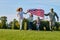 Shot of patriotic family running with flag.