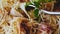 Shot of person eating italian pasta noodles in bowl, focus on twirling fork, slomo