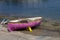 Shot of a pink skiff boat parked at the seashore on a beautiful spring day