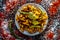 Shot of Piyaz pakora/bhaji/bhajji/bhajiya/bajji in a glass plate with some fresh green chilies and red chili powder along with it