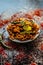 Shot of Piyaz pakora/bhaji/bhajji/bhajiya/bajji in a glass plate with some fresh green chilies and red chili powder along with it