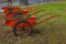 Shot of red wheelbarrows with blue and yellow violets in a park