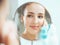 Shot of a reflection of a young woman applying the powder in the