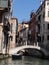 Shot of romantic canal in Venice with gondola and  elegant buildings