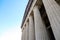 A shot of rows of tall stone pillars at The Parthenon with clear blue sky at Centennial Park