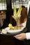 Shot of a server serving meatballs and a salad in a cocktail glass in a fancy restaurant