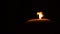 Shot of a single candle burning, isolated on black background. Snuffing out a candle. Excellent text space.