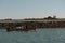 Shot of small wooden boat on blue green water clearing the inlet and going out to sea in dwarka