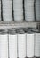 Shot of stacks of many white plates on a wire rack shelf in a commercial kitchen