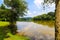 A shot of the still waters of the Chattahoochee river with lush green trees reflecting off the water with a boardwalk