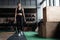 Shot of strong woman standing in crossfit gym and looking away. Confident fitness female model in sportswear.