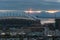 Shot of sunset over Centurylink field stadium, two ferries in Puget Sound and Olympic National Park from the Dr. Jose Rizal Park,