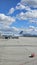 A shot of the tarmac at the Ontario International Airport with planes and runways, blue sky and clouds in Ontario California