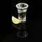 Shot of tequila with salt rimmed glass and wedge of lime. Conceptual image