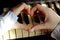 Shot Of An Unidentifiable Female Hands Making A Heart Shape Over A Piano.