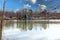 A shot of the vast still waters of the Catawba River with autumn trees along the banks of the river reflecting off the water