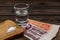 Shot of vodka with money of the Soviet Union and piece of bread with salt on an old wooden table.