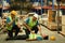 Shot of warehouse workers are helping and giving the injured first aid to colleague lying unconscious on concrete floor