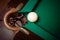 Shot of white ball going in billiard pocket