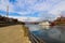 A shot of a white and red steam boat sailing on the Cumberland River near the John Seigenthaler Pedestrian Bridge