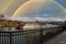 A shot of a white and red steam boat sailing on the Cumberland River near the John Seigenthaler Pedestrian Bridge