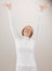 Shot of woman in white reaching with arms raised