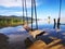 Shot of wooden swings over a lake with forests in the background