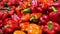 Shot of workers hand picking and placing red bell peppers on conveyor belt for further processing in the food industry